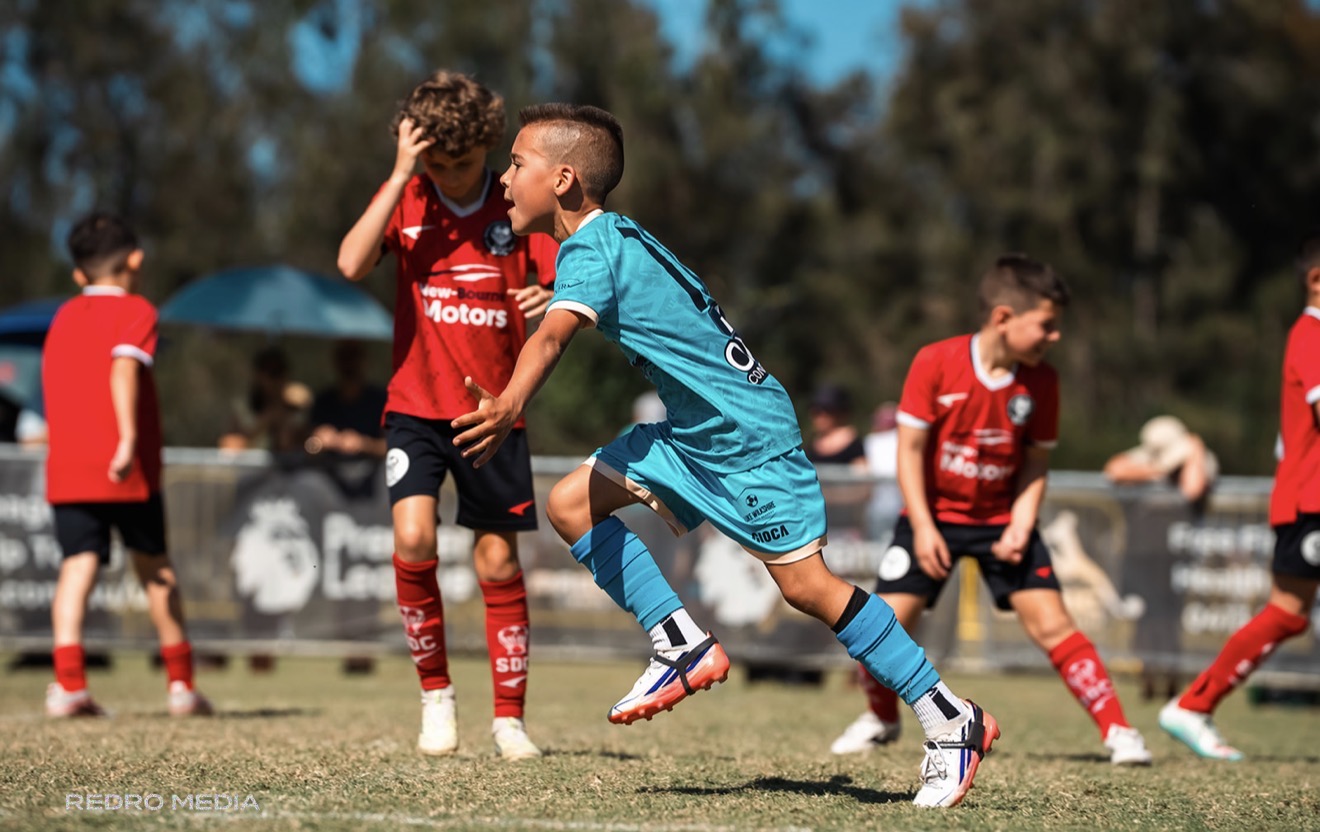 Frankie in teal kit exploding away from defenders